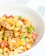 A vibrant bowl of mixed greens topped with colorful Indian spices and fresh veggies.