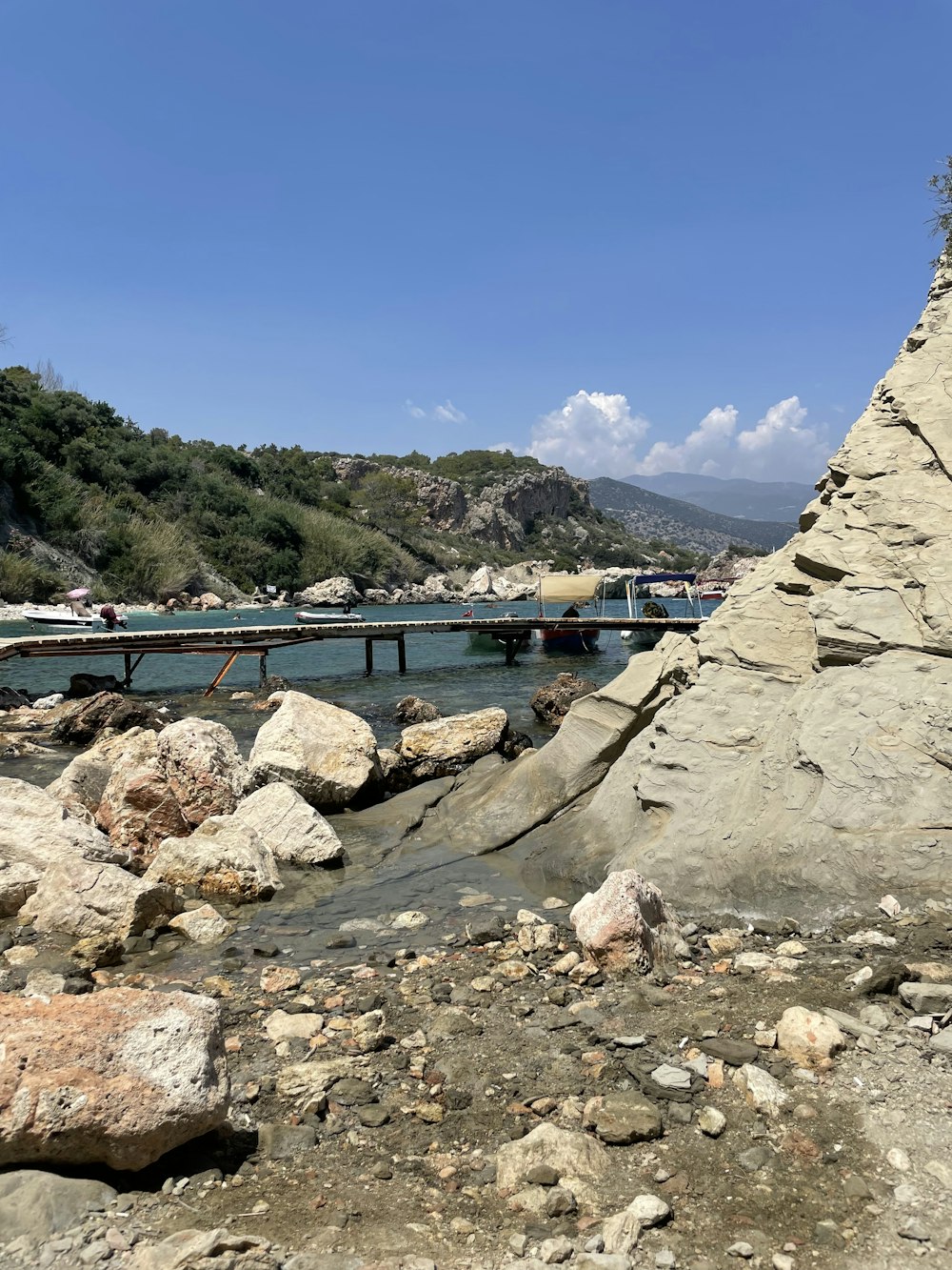 a bridge over a body of water surrounded by rocks