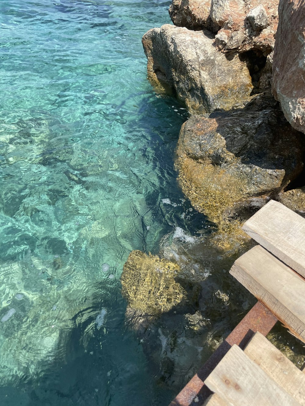 a wooden bench sitting next to a body of water