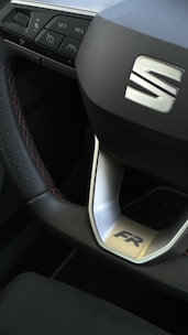 A collection of different branded steering wheels on a display.