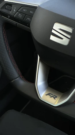 A display of premium car accessories including steering wheels and alloy wheels.