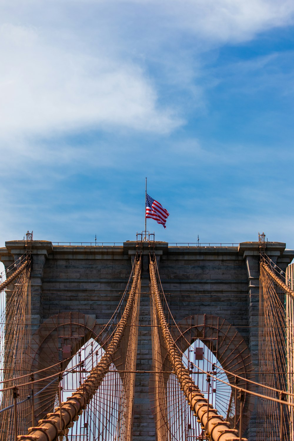 a view of the top of a bridge with a flag on top