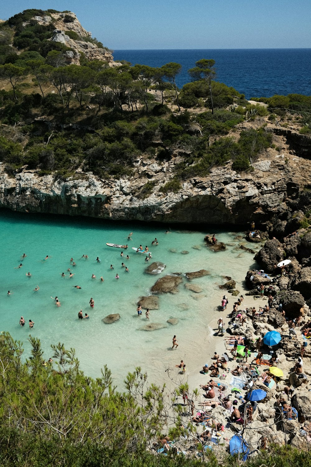 a group of people on a beach near a body of water