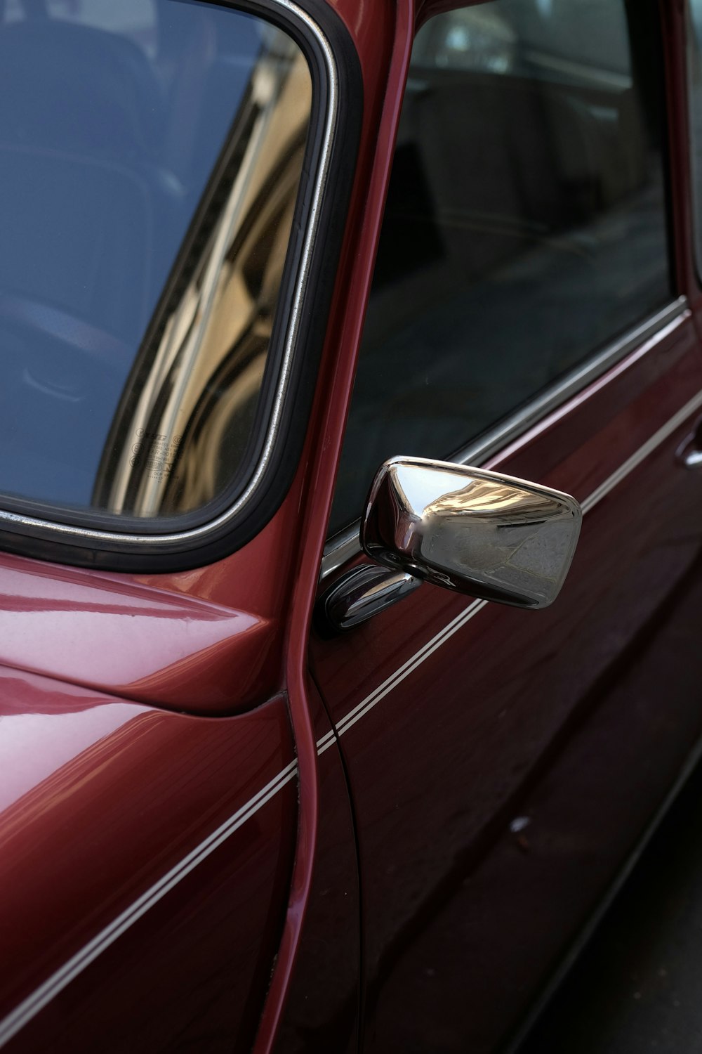 a close up of a car door with a mirror