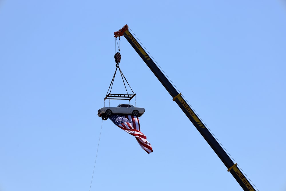 a crane lifting a flag into the air
