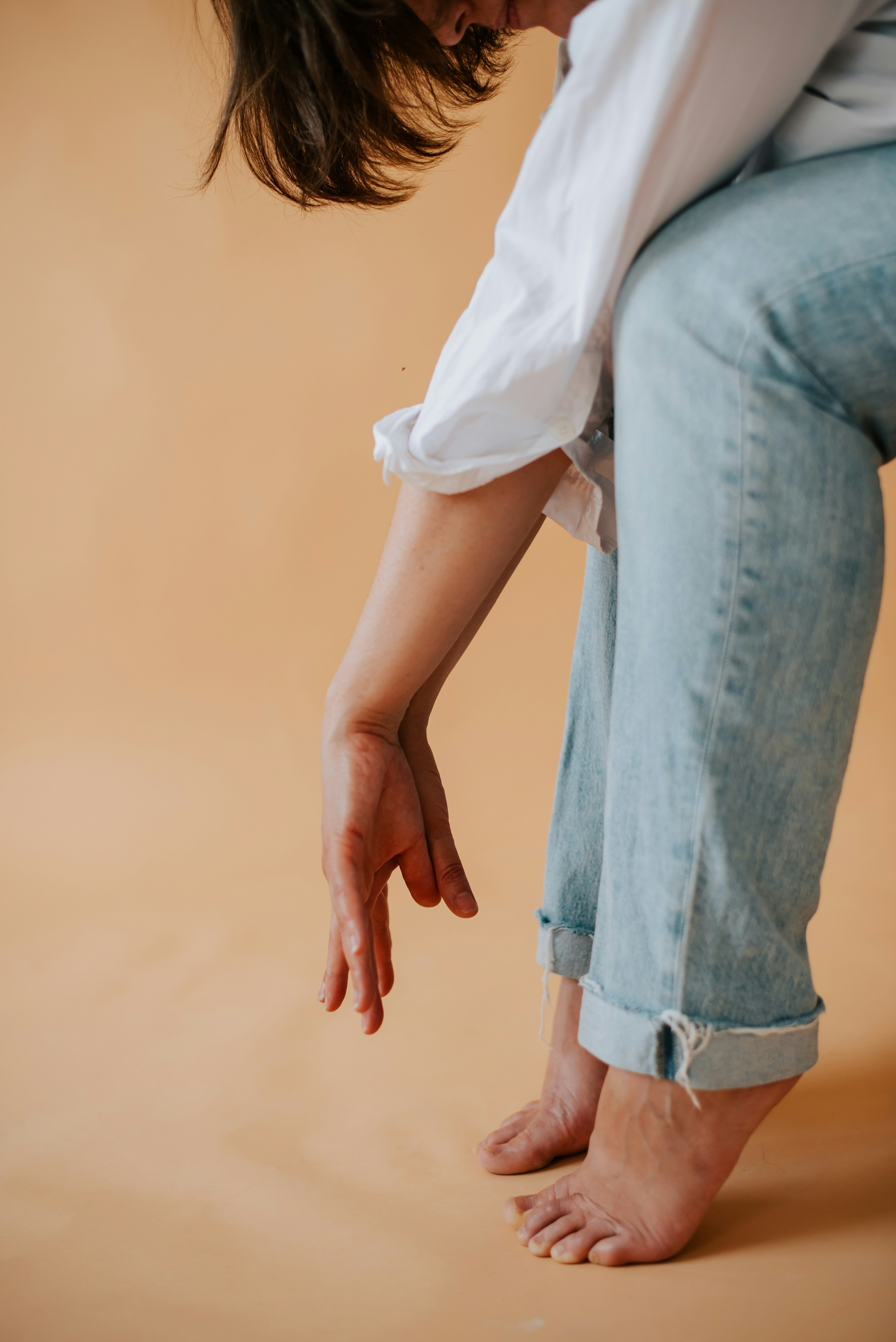 a woman kneeling down with her foot on the ground