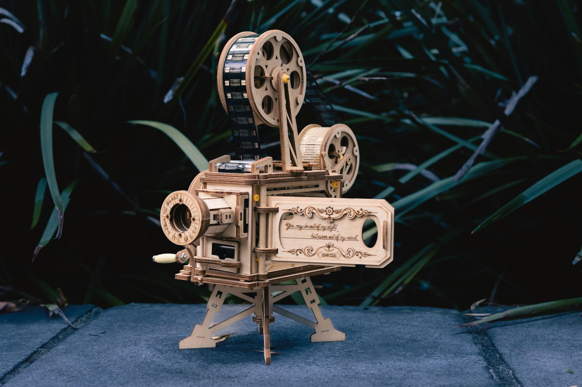 a wooden model of a movie projector
