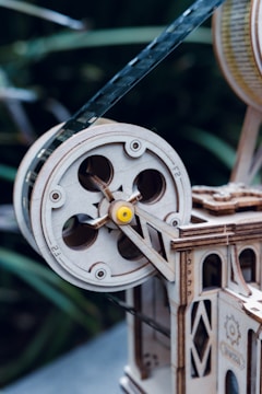 Close-up of a detailed mechanical assembly with laser-engraved wooden parts.