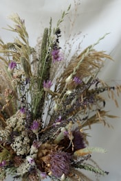 A rustic bridal bouquet with wildflowers and dried grasses, perfect for an outdoor 2026 wedding.