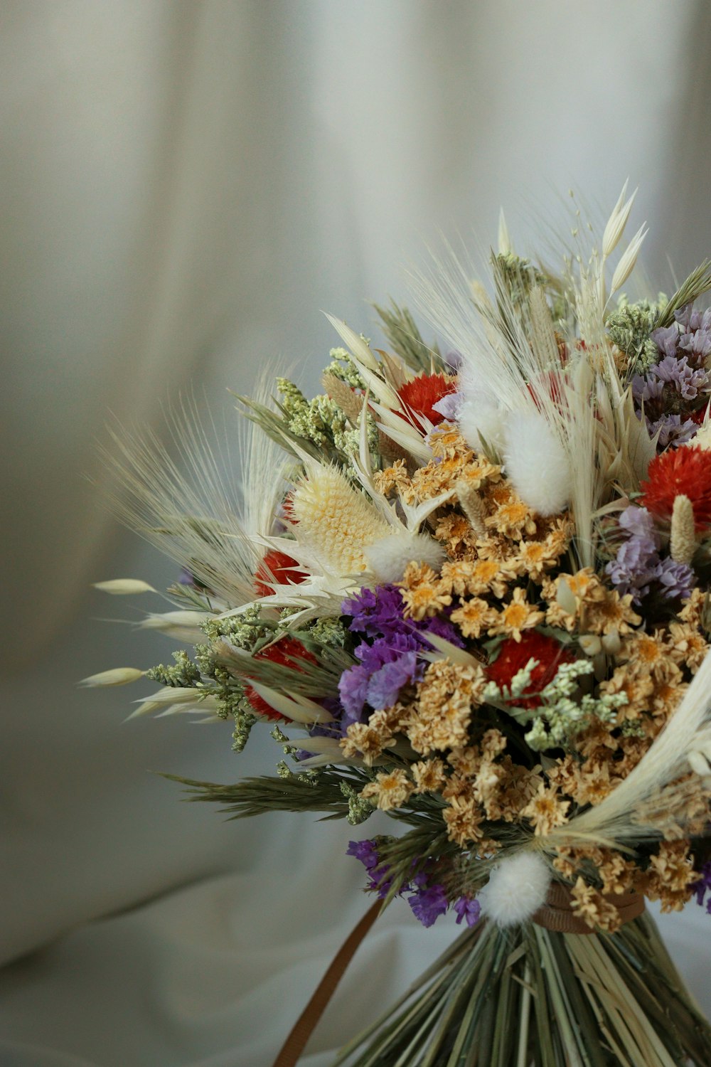 a bouquet of dried flowers on a white background