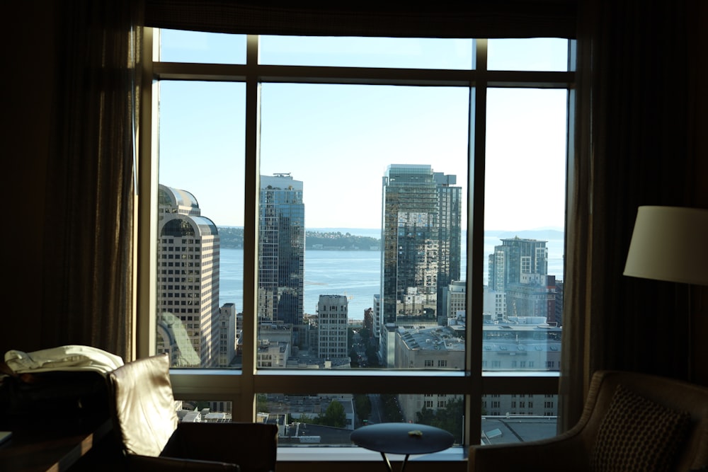 a living room with a large window overlooking a city