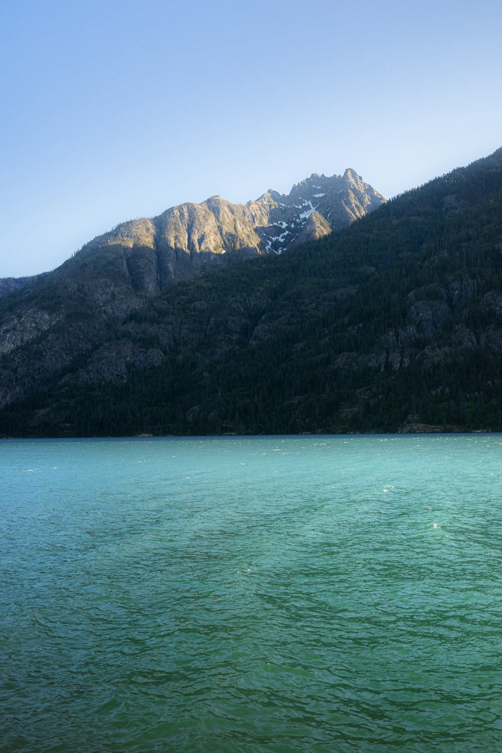 a large body of water with mountains in the background