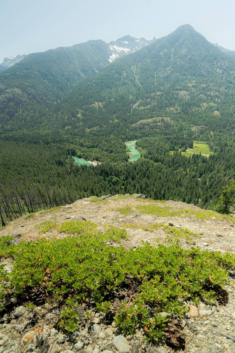 a view of a mountain range with a lake in the distance