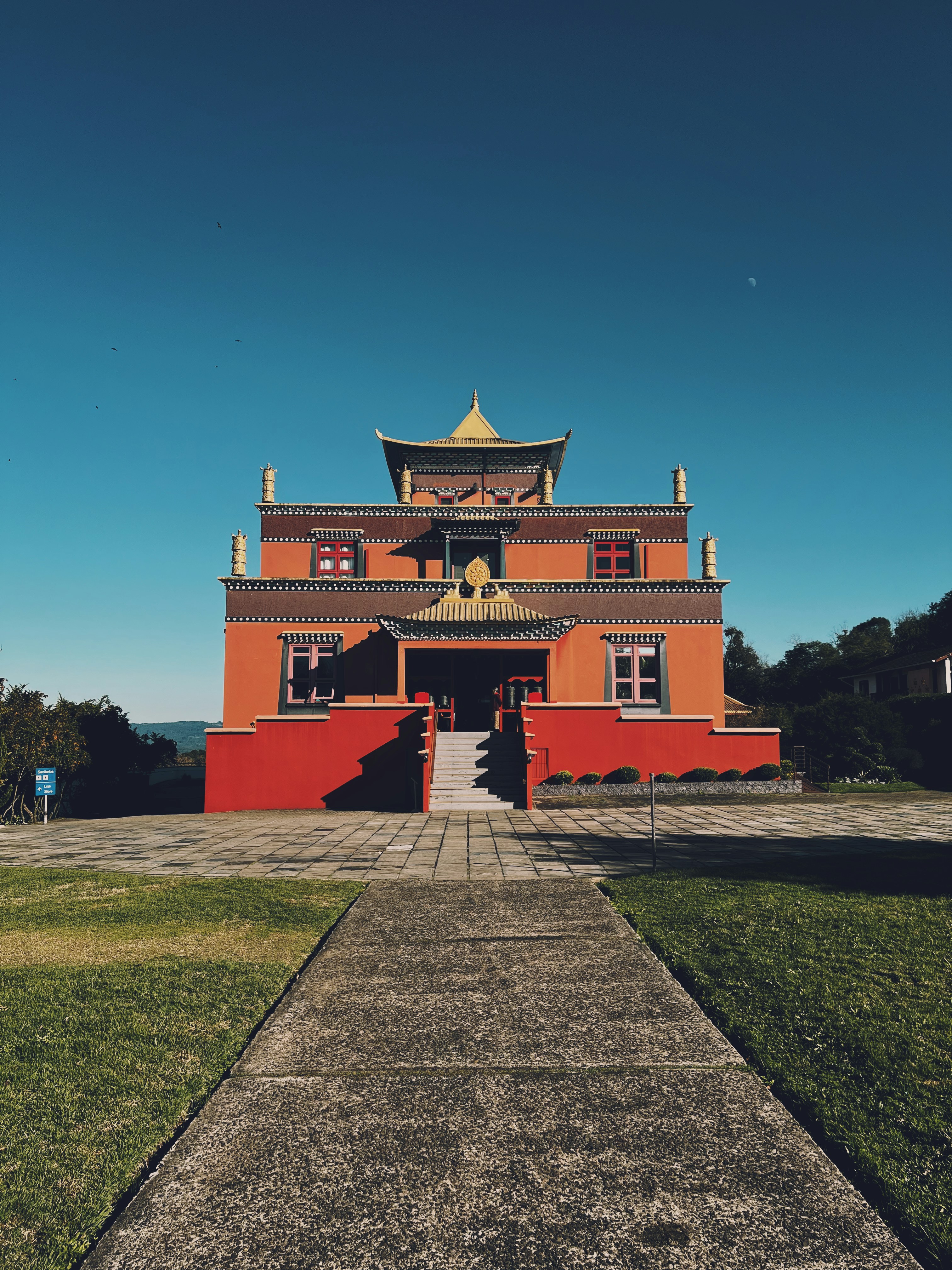 a red building with a yellow roof on a sunny day