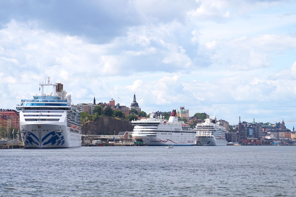 two cruise ships in the water near a city