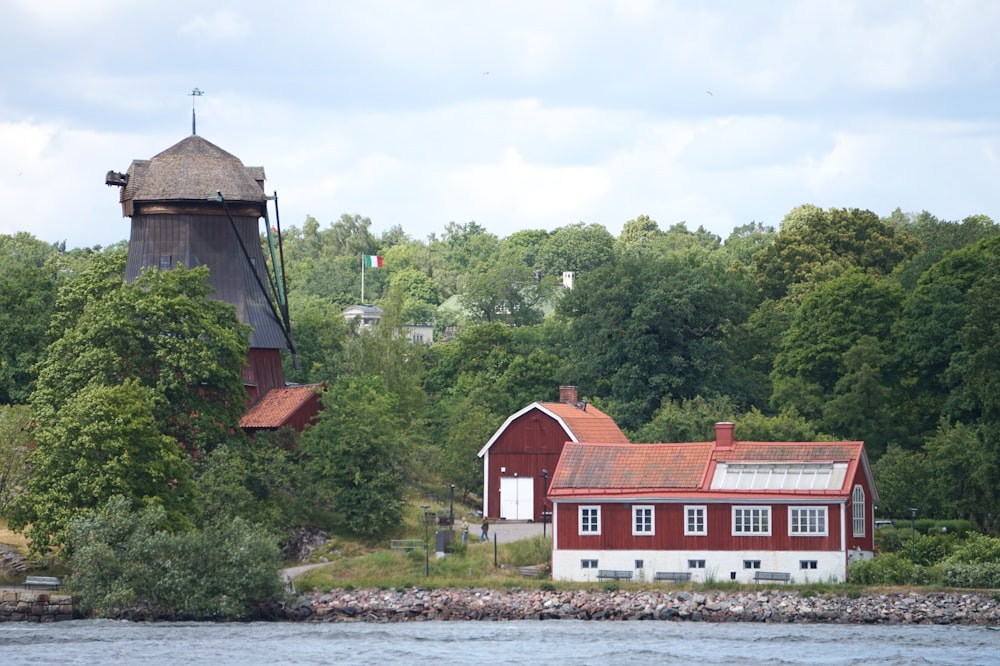 a red house with a water tower in the background