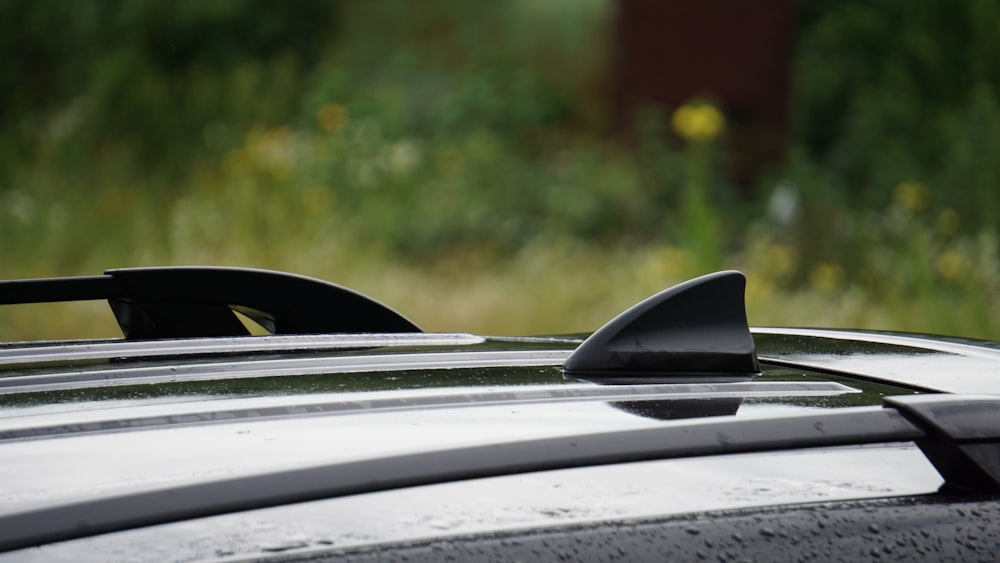 a close up of a car roof with rain drops on it