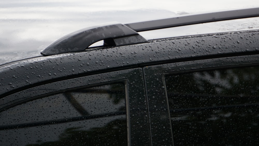 a car with rain drops on the windshield