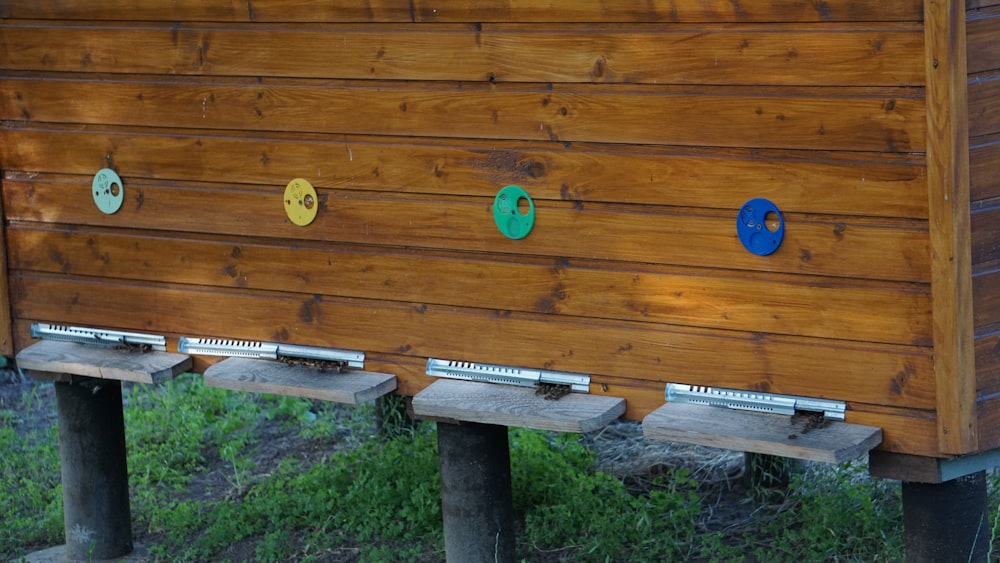 a wooden structure with four different colored circles on it