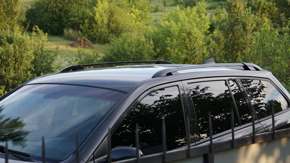 a black van parked in front of a forest