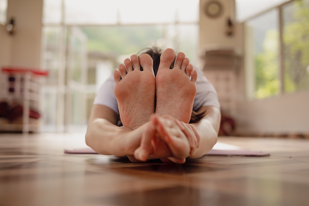 a person laying on the floor with their feet up