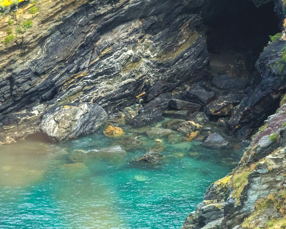 a body of water near a rocky cliff