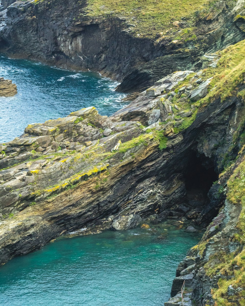 a body of water surrounded by a rocky cliff