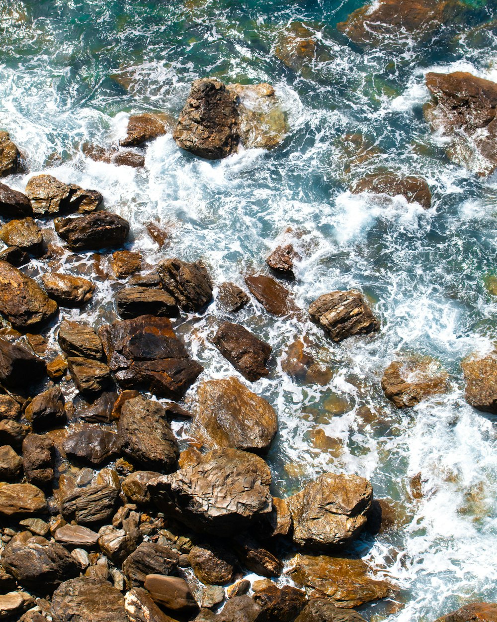 a view of a rocky beach with a bunch of rocks in the water