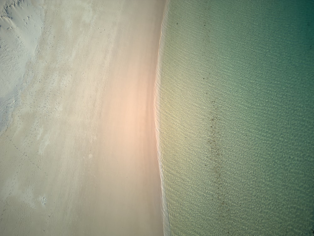 an aerial view of a sandy beach and ocean