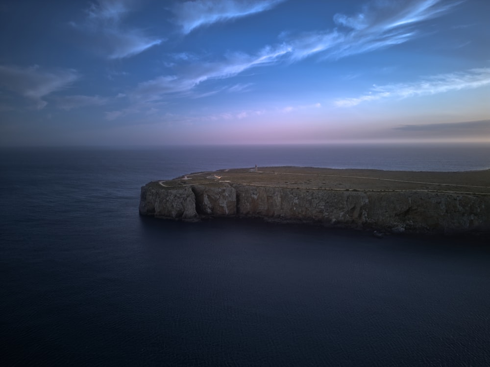 a large body of water with a small island in the middle of it