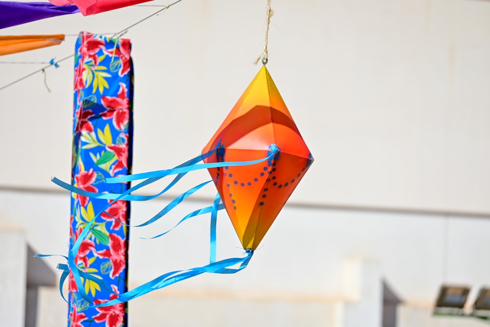 a colorful kite hanging from a pole outside