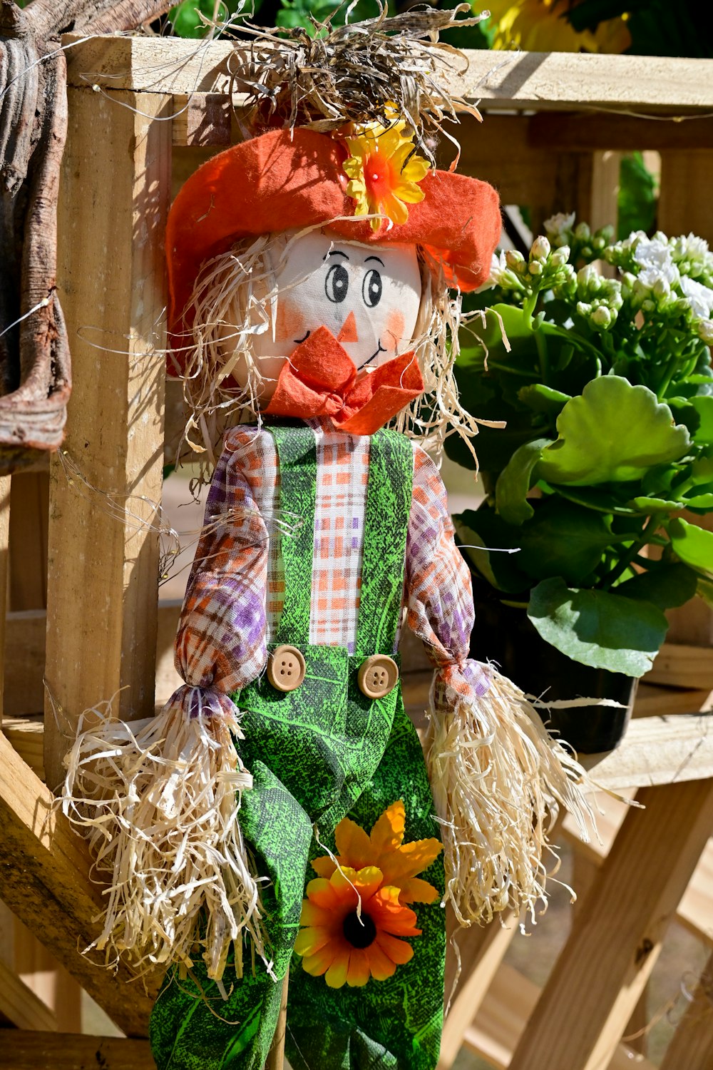 a scarecrow with a hat and green pants