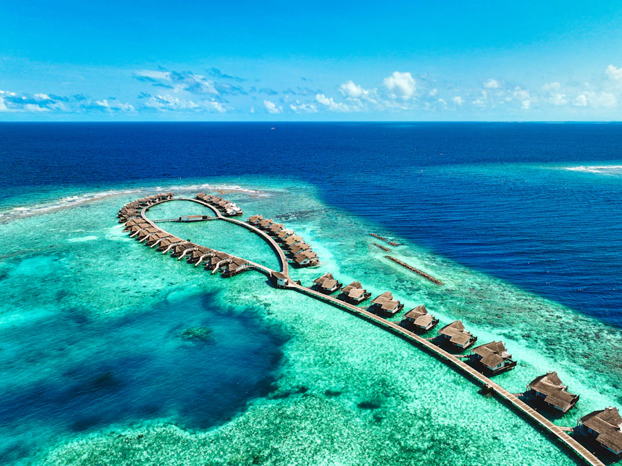 Resort island and its overwater villas seen from the air