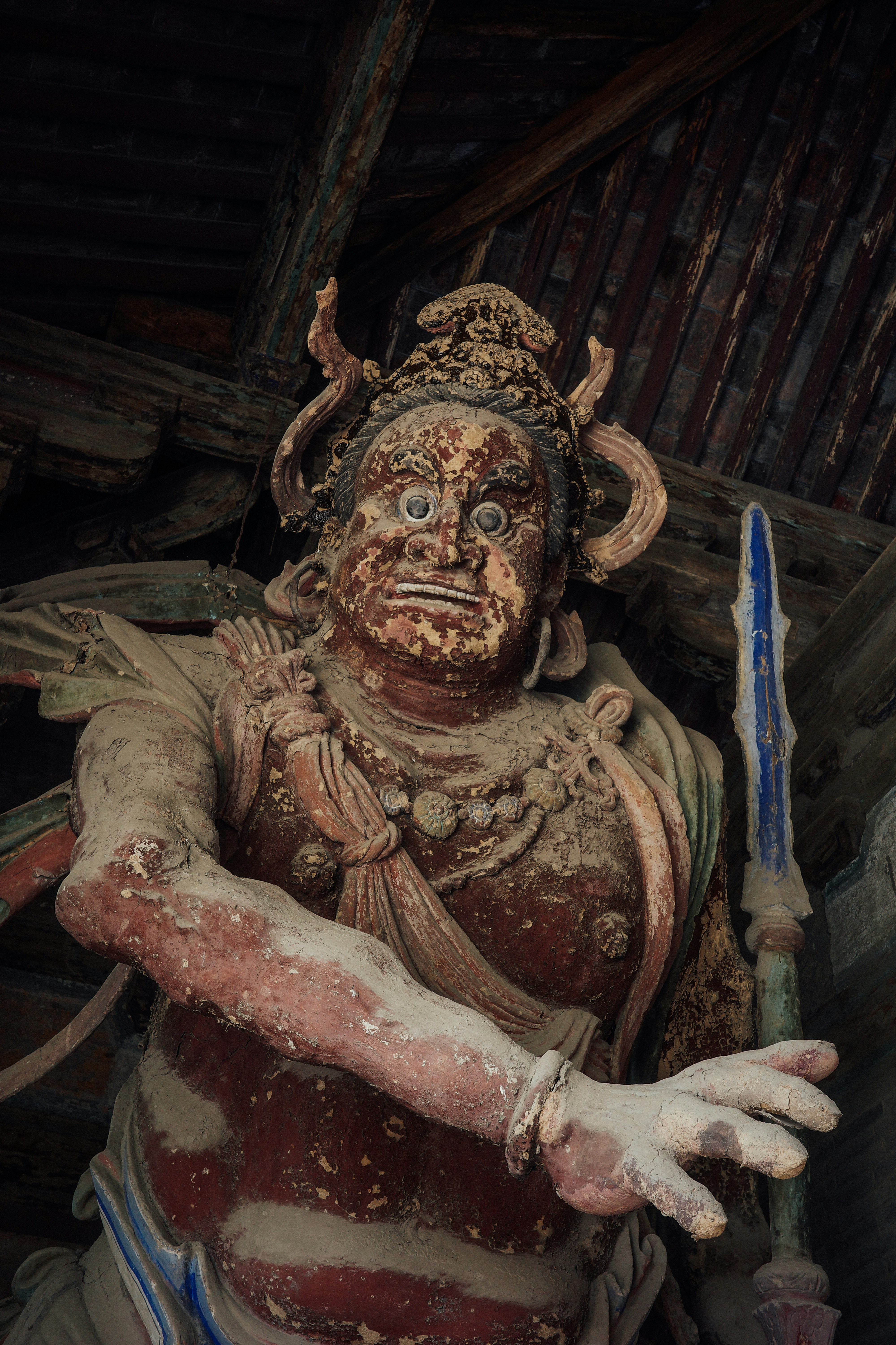 a statue of a demon holding a knife