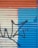 A wall with a metal roller shutter painted in three sections: orange on top, beige in the center, and blue on the right. A black graffiti outline resembling abstract or stylized shapes extends across the surface.