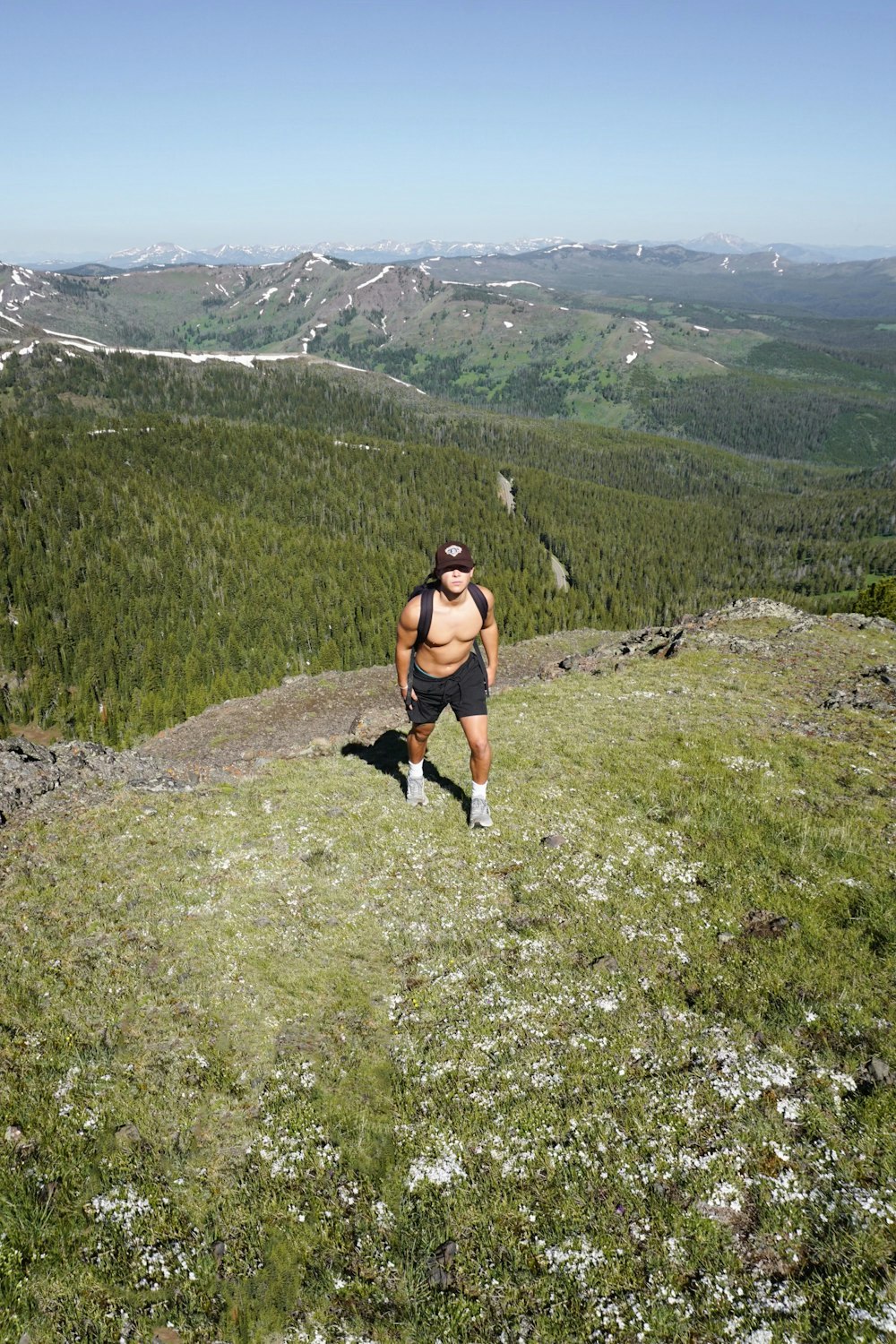 a man hiking up a hill in the mountains