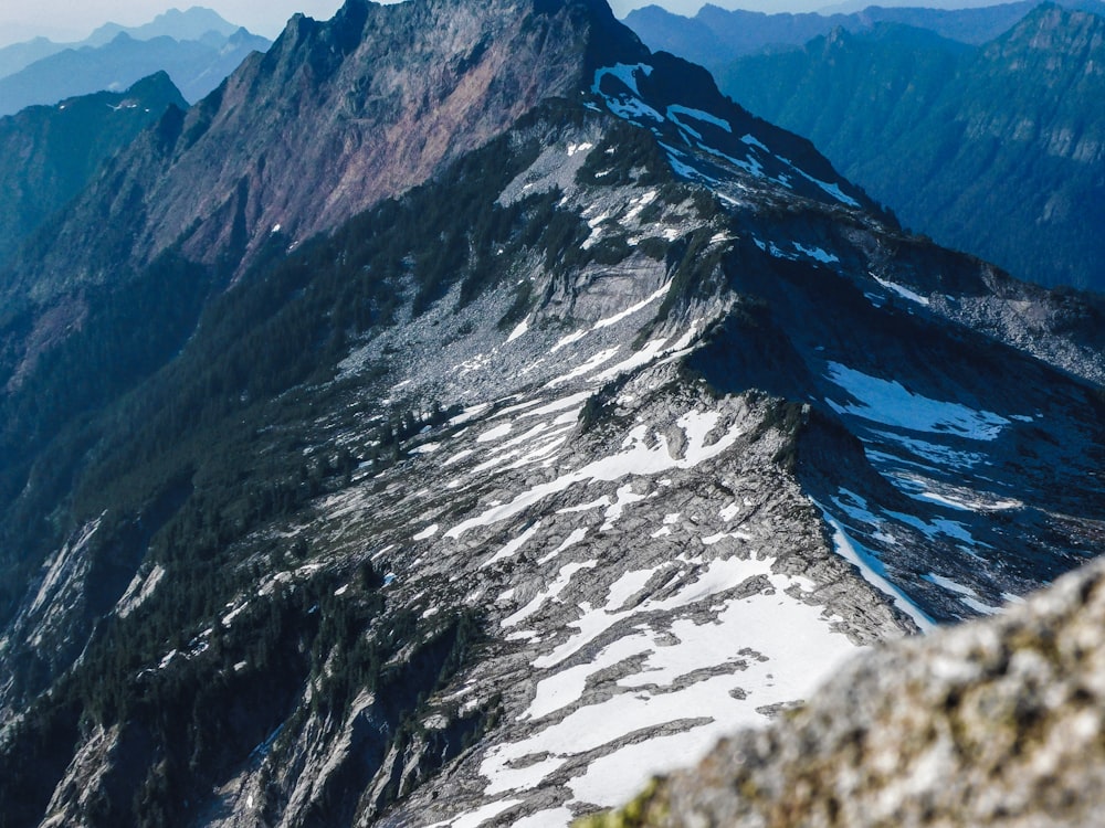 a view of a snow covered mountain from the top of a mountain