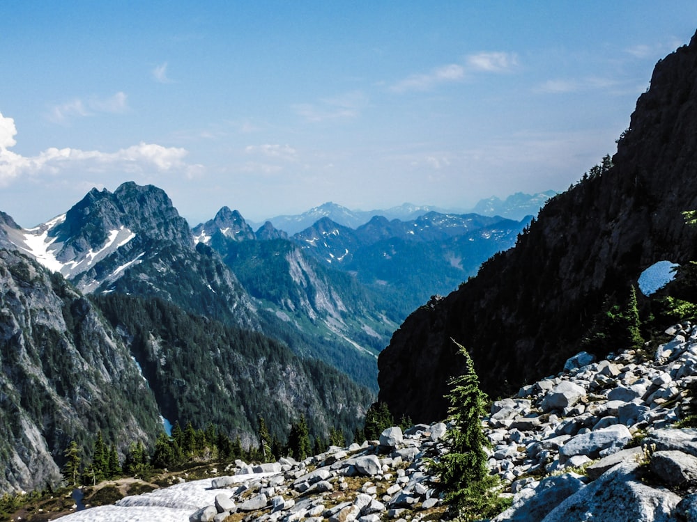 a view of a mountain range with rocks and trees