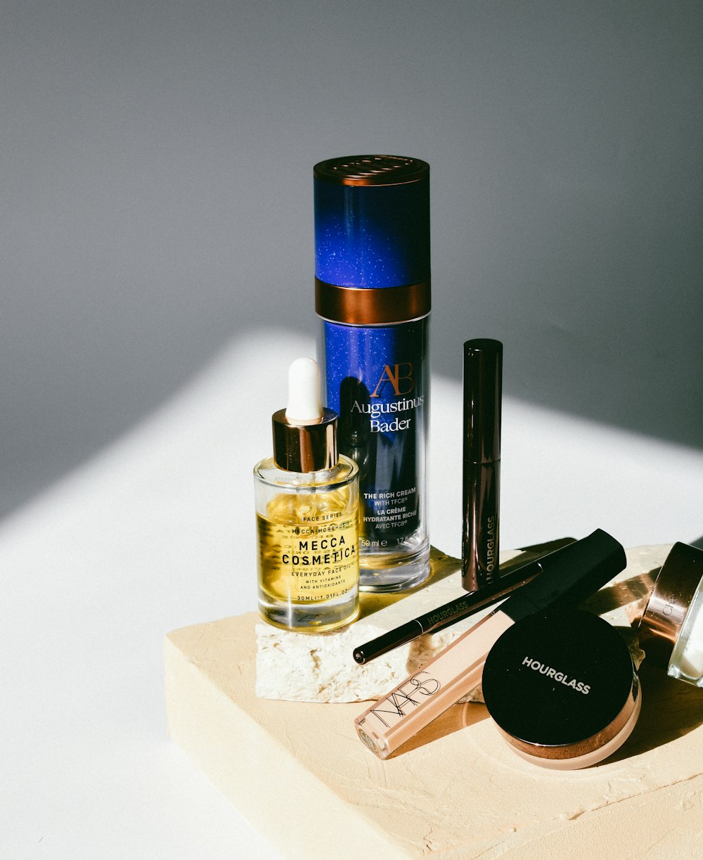 a table topped with cosmetics and a bottle of perfume