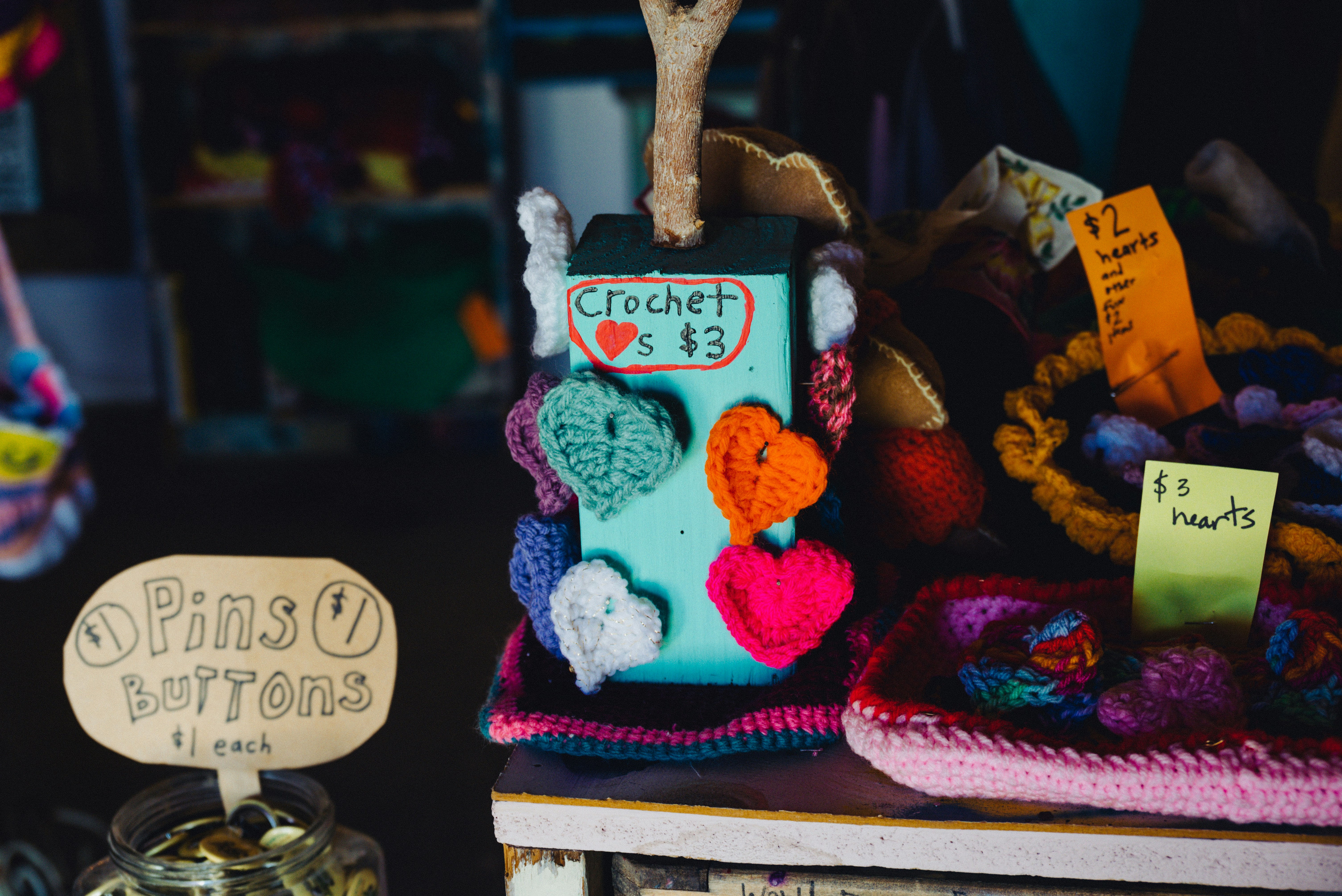 a display of crocheted items for sale at a market
