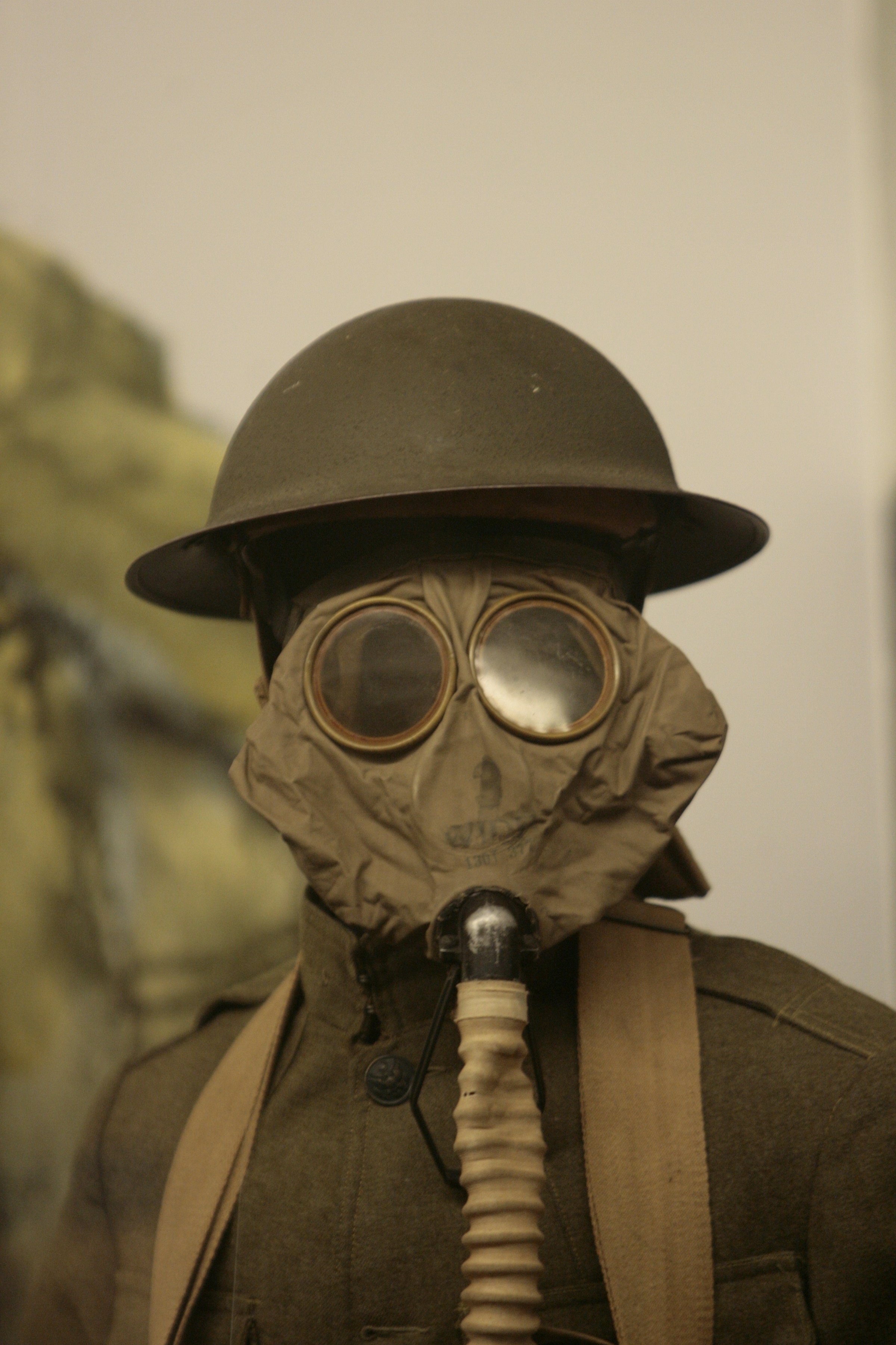 a man wearing a gas mask and a hat
