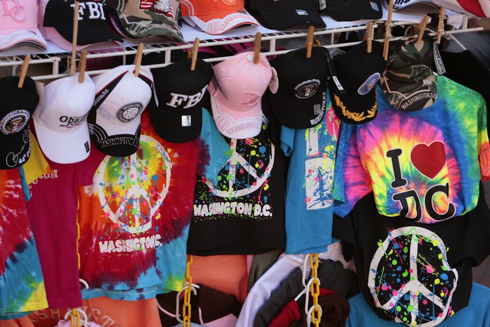 a rack of t - shirts with peace signs on them