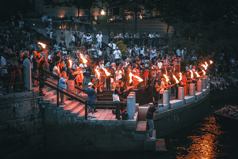 a large group of people standing on top of a river