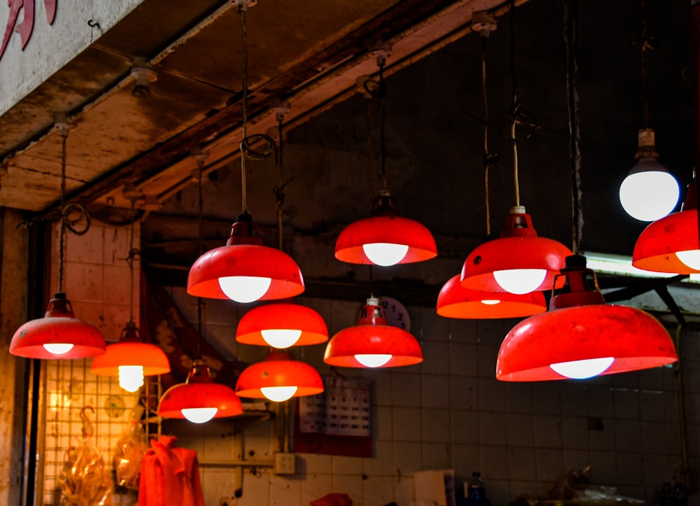 a bunch of red lights hanging from a ceiling