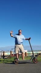 A happy person handing over keys of an electric scooter to another rider in a sunny urban setting