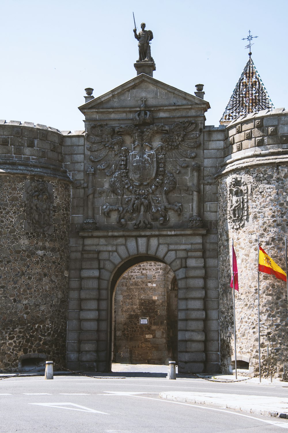 a large stone building with a statue on top of it