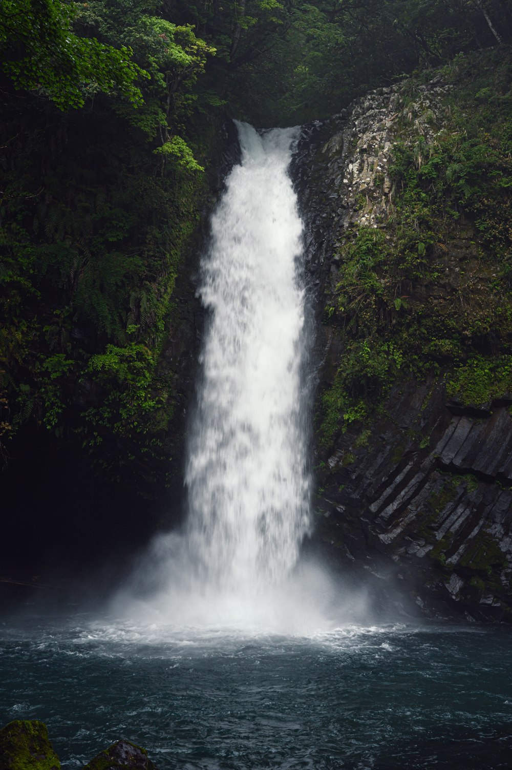 a large waterfall with water cascading down it's sides