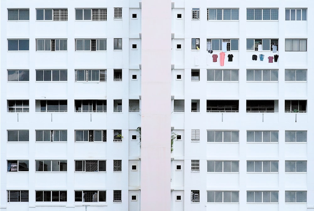 a tall white building with lots of windows