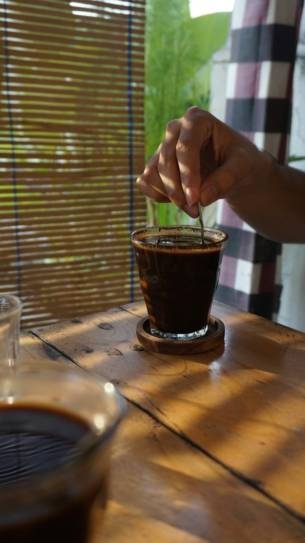 a person sitting at a table with a cup of coffee