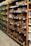 Shelves in a grocery store are stocked with various packaged food items. The left side features a range of cooking oils, while the right side displays a selection of baked goods or packaged snacks. Each shelf is orderly, with products neatly arranged in rows and labels visible for pricing.